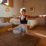 elderly woman meditating inside the room